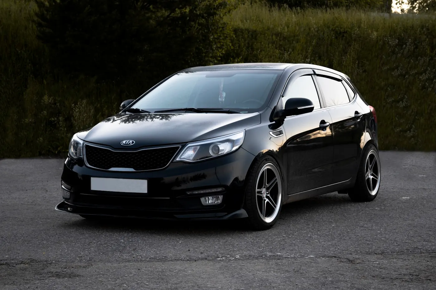 Black hatchback with restored deep gloss paint after detailing