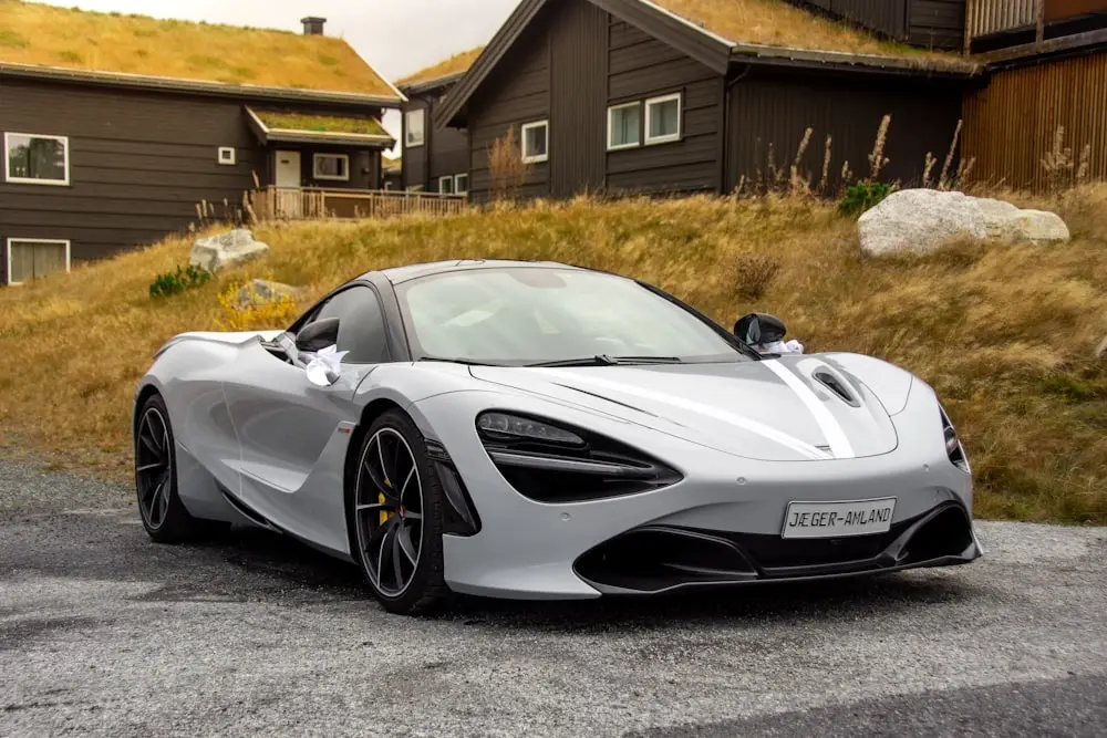 White McLaren 720S with spotless paint in front of a hillside