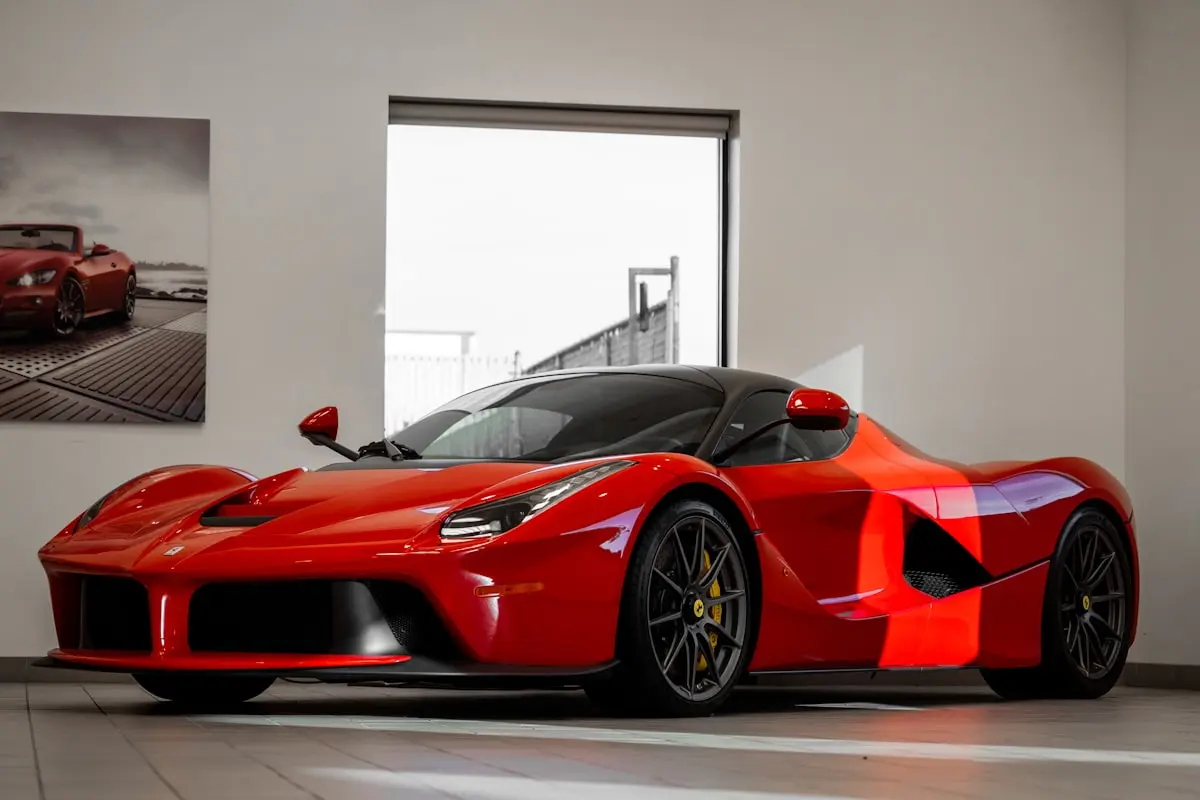 Red Ferrari with glossy ceramic-coated paint in a showroom